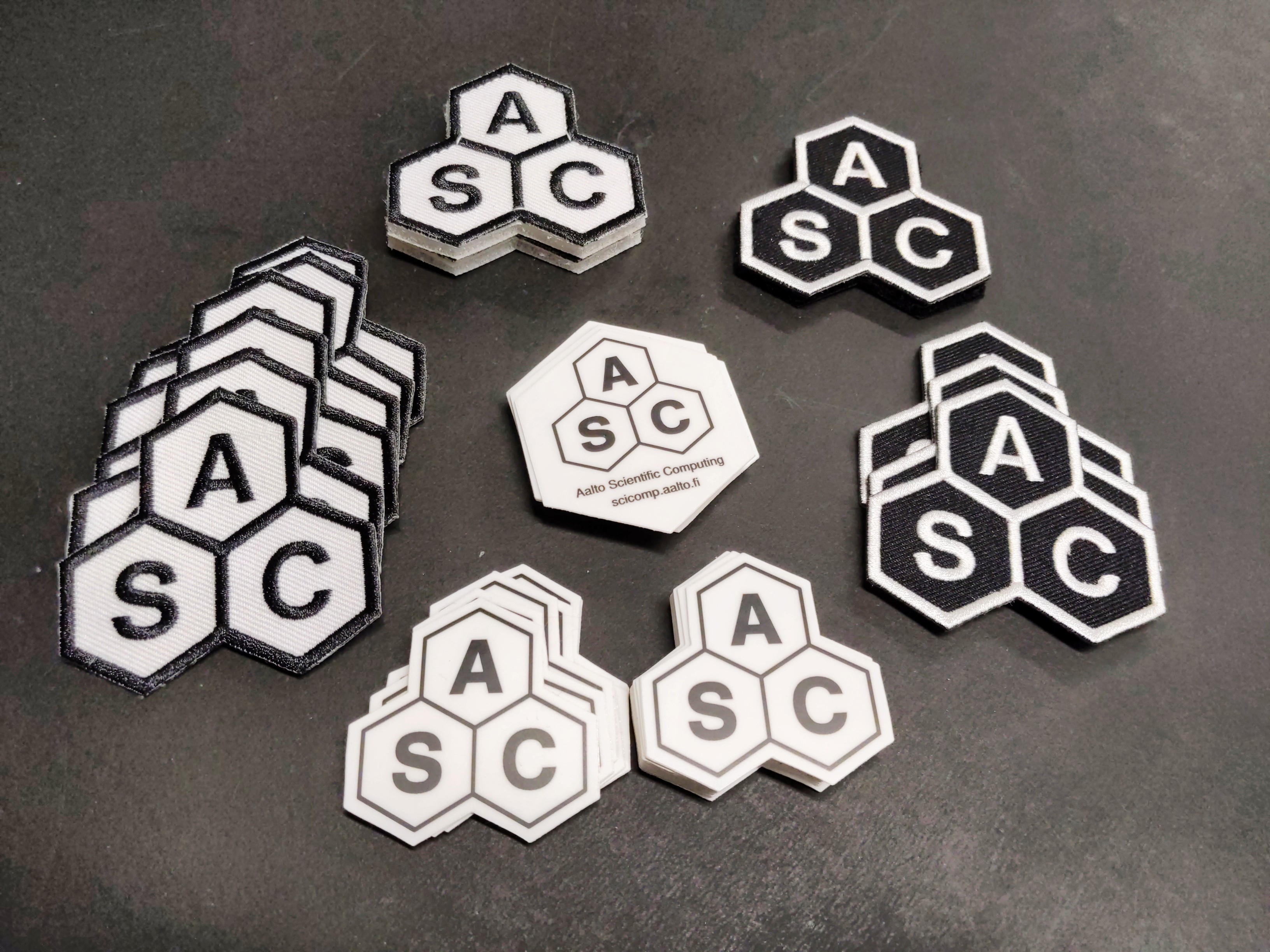 Picture with hexagonal stickers and patches laid out on a table.  We have far more than you see here.